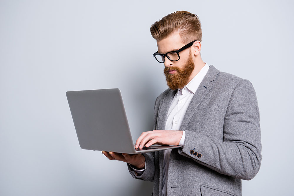 businessman in grey suit on laptop