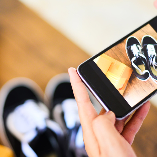 young woman taking photo sneakers with camera smartphone for post to sell online on the internet market website / selling online ecommerce shipping online shopping delivery and order